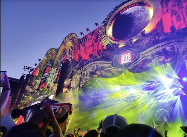 Image of a stage with many green and purple lights.