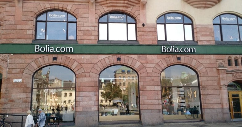 Facade of a classic brick building with shop windows and the Bolia.com brand sign