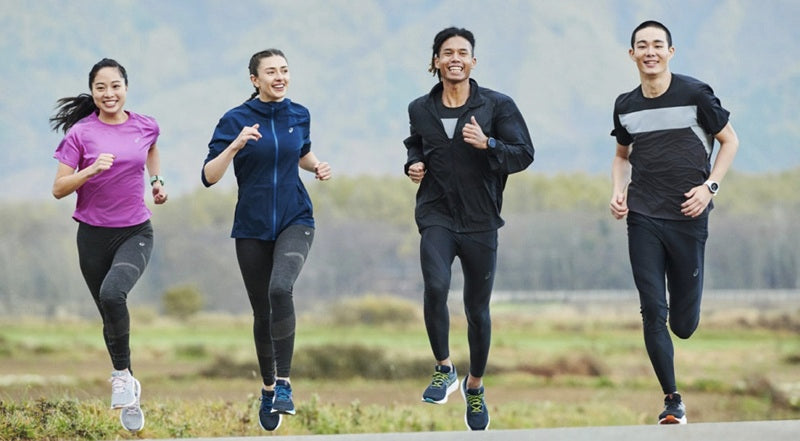 Un grupo de dos hombres y dos mujeres practican running muy sonrientes