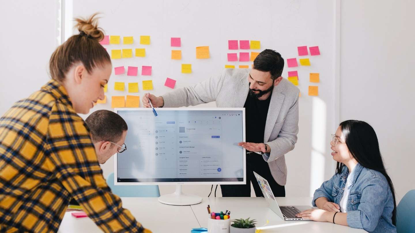 People in an office discussing research work