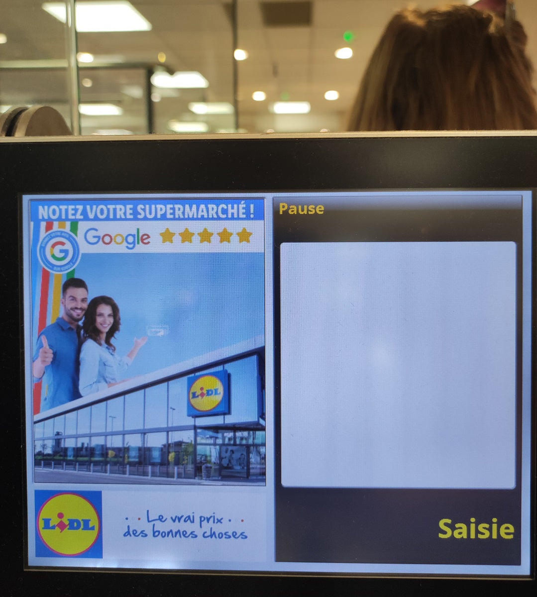 Image of a supermarket self-checkout screen encouraging customers to leave a Google review.