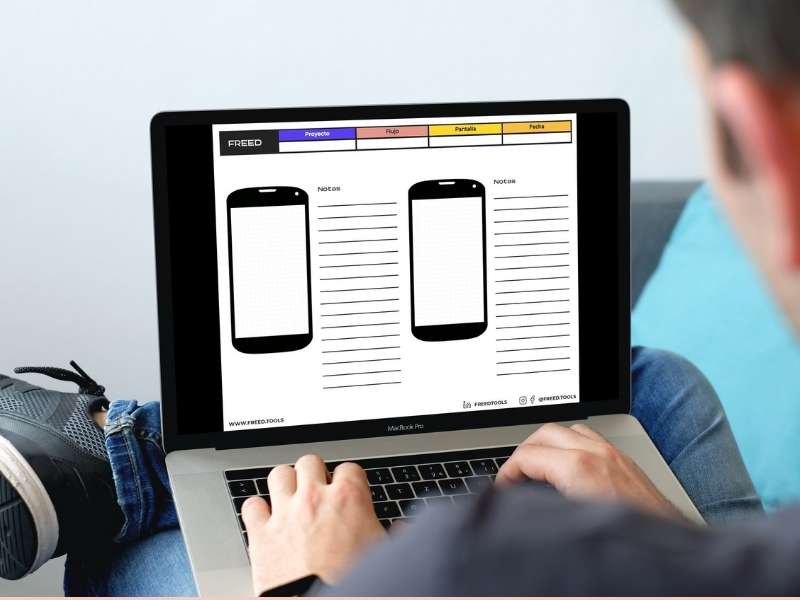 Person looking at a mobile interface design template on a computer.