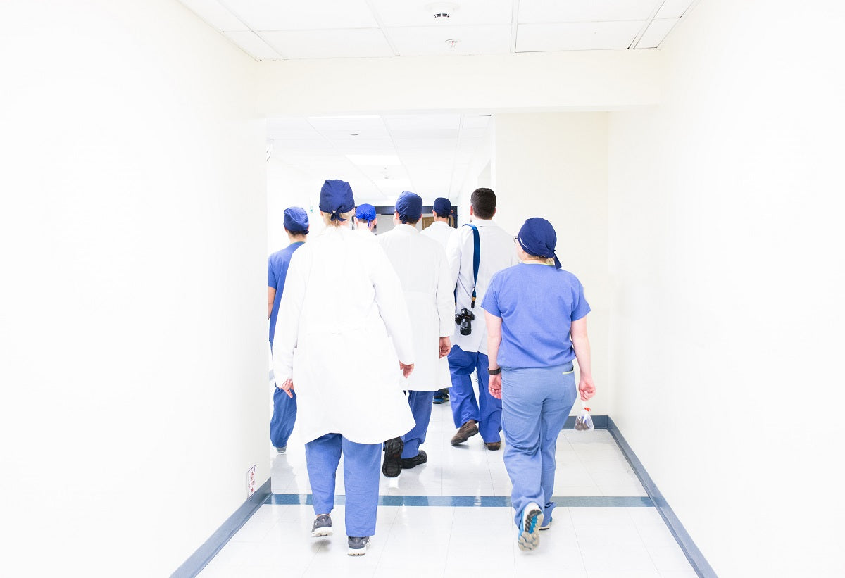 Healthcare professionals walking down a hospital corridor.