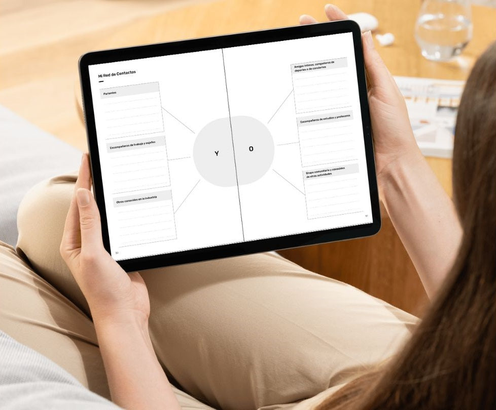 A woman holds a tablet showing one of the planner's activities dedicated to networking.