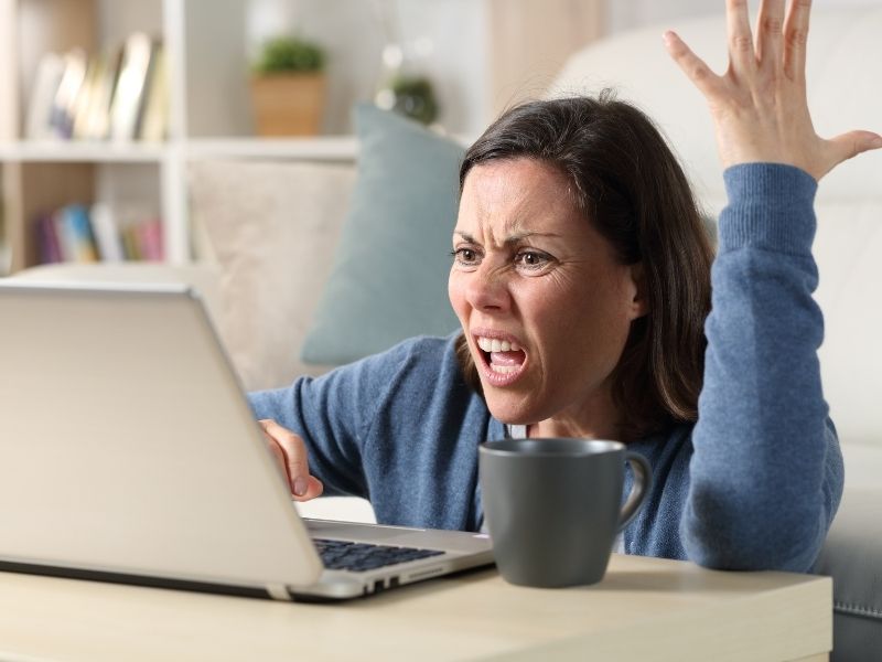 Woman upset by a problem she saw on her computer.