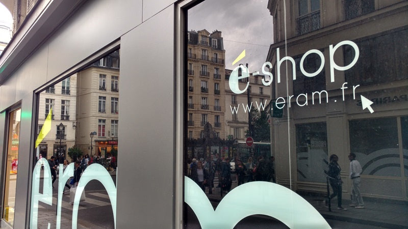 Shop windows reflecting a large classic building