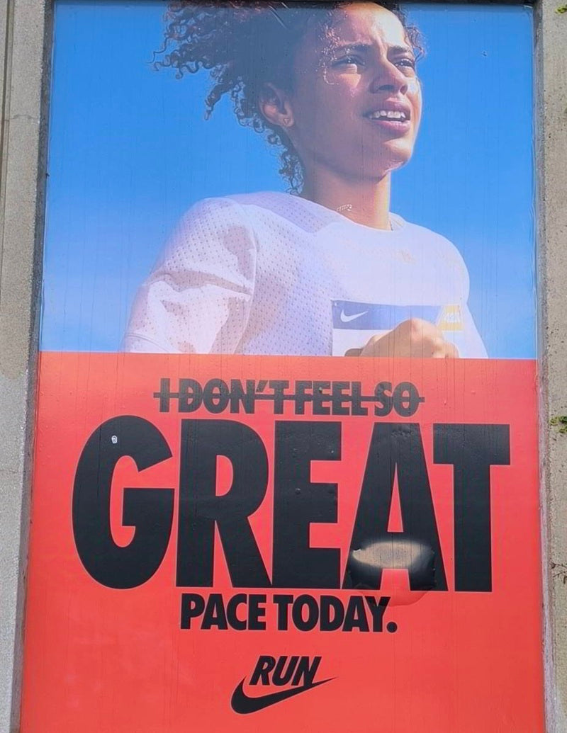 Nike advertisement in Chicago showing a woman running and a slogan